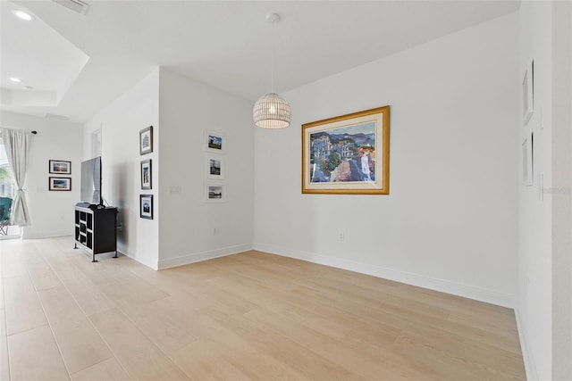 spare room with light wood-style floors, recessed lighting, and baseboards