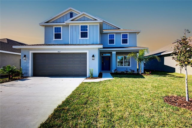 view of front of property with driveway, a garage, a lawn, and board and batten siding