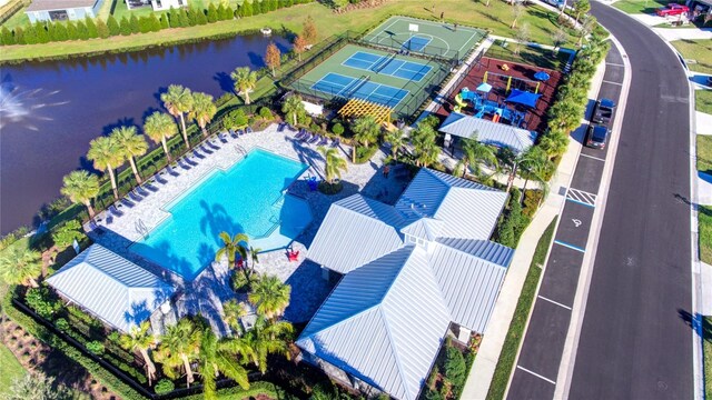 drone / aerial view of a pool and a large body of water