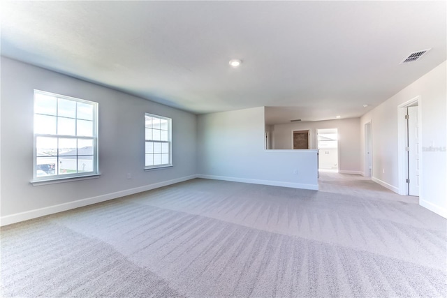 unfurnished living room featuring carpet floors, baseboards, and recessed lighting