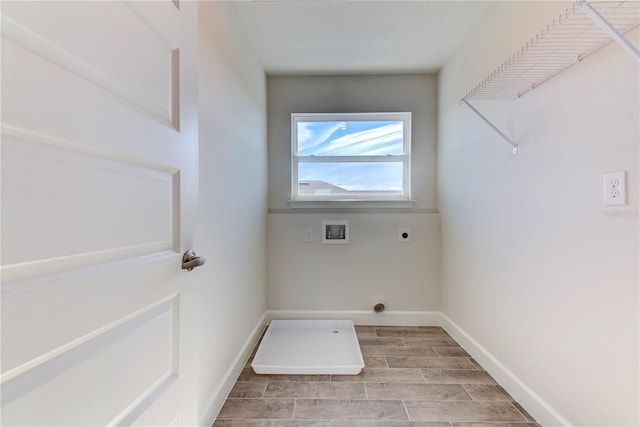 laundry area with hookup for a washing machine, hookup for an electric dryer, wood finish floors, and baseboards