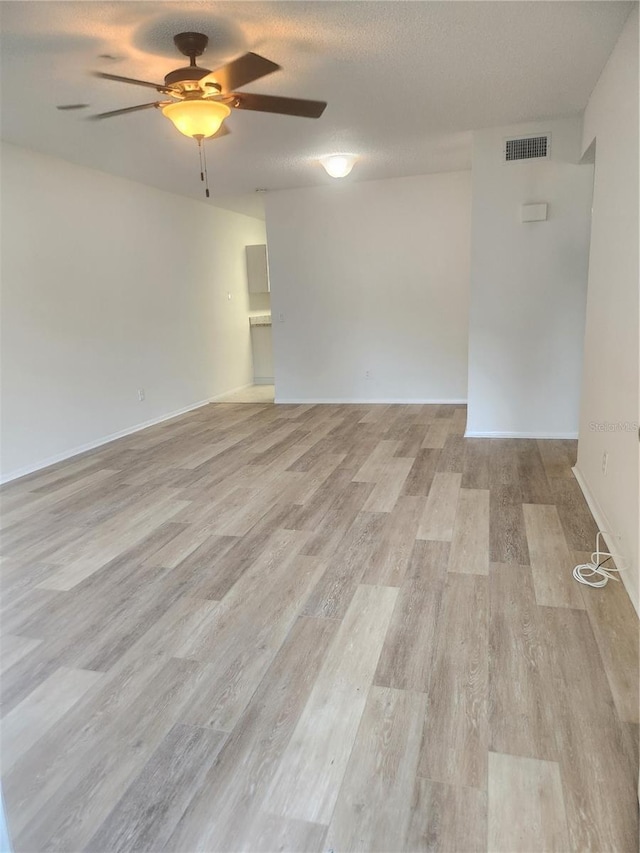 2293 Swedish Dr Unit 11, Clearwater, FL 33763 - spare room featuring a ceiling fan, light wood finished floors, and baseboards