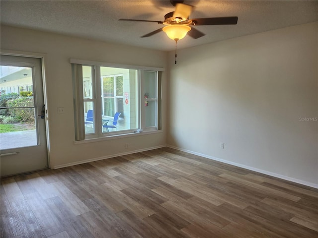 2293 Swedish Dr Unit 11, Clearwater, FL 33763 - unfurnished room featuring wood finished floors, ceiling fan, baseboards, and a textured ceiling