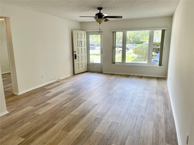 2293 Swedish Dr Unit 11, Clearwater, FL 33763 - unfurnished room featuring wood finished floors, a ceiling fan, a textured ceiling, and baseboards