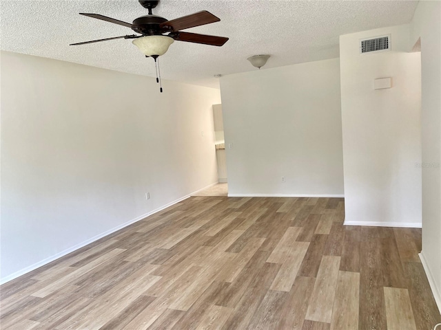 2293 Swedish Dr Unit 11, Clearwater, FL 33763 - empty room featuring a textured ceiling, a ceiling fan, wood finished floors, and baseboards