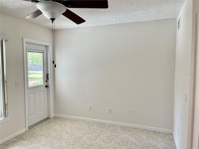 2293 Swedish Dr Unit 11, Clearwater, FL 33763 - empty room featuring a textured ceiling, a ceiling fan, light tile patterned floors, and baseboards