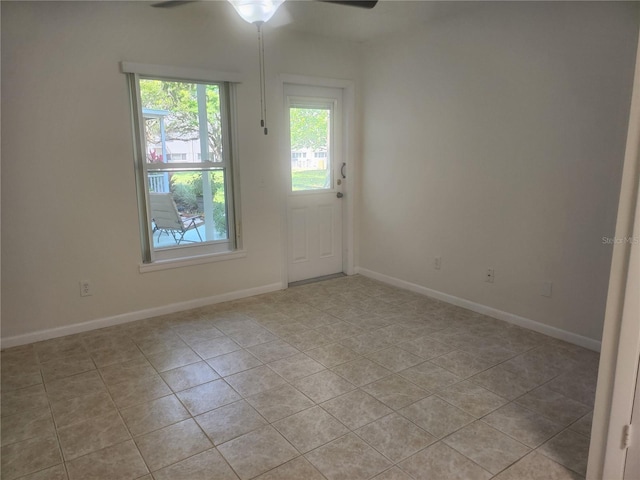 2293 Swedish Dr Unit 11, Clearwater, FL 33763 - empty room featuring a ceiling fan, light tile patterned floors, and baseboards