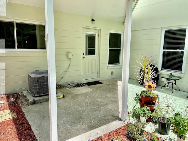 2293 Swedish Dr Unit 11, Clearwater, FL 33763 - doorway to property with cooling unit and a patio