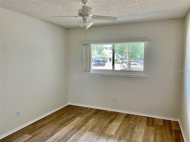 2293 Swedish Dr Unit 11, Clearwater, FL 33763 - empty room featuring wood finished floors, baseboards, ceiling fan, and a textured ceiling