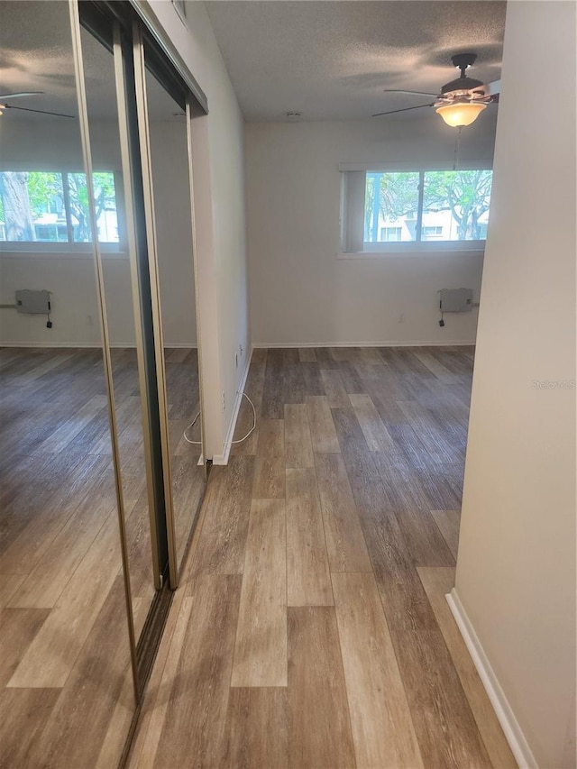 2293 Swedish Dr Unit 11, Clearwater, FL 33763 - hallway featuring wood finished floors, baseboards, and a textured ceiling