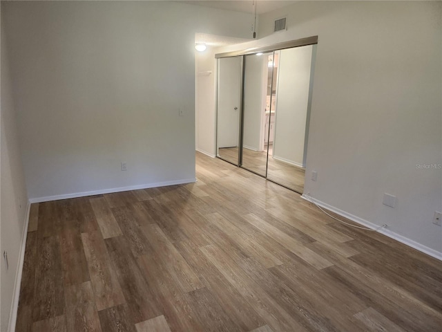 2293 Swedish Dr Unit 11, Clearwater, FL 33763 - unfurnished bedroom featuring wood finished floors, baseboards, and a closet