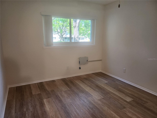 2293 Swedish Dr Unit 11, Clearwater, FL 33763 - spare room featuring dark wood-style flooring and baseboards