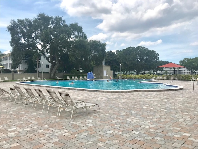 2293 Swedish Dr Unit 11, Clearwater, FL 33763 - community pool featuring a patio area and fence