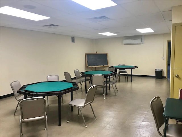 2293 Swedish Dr Unit 11, Clearwater, FL 33763 - recreation room featuring a wall mounted AC, a drop ceiling, and baseboards