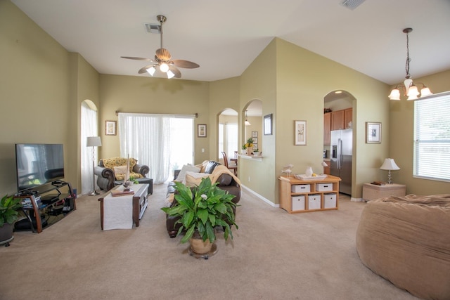 11021 Silver Dancer Dr, Riverview, FL 33579 - living room with arched walkways, light colored carpet, a ceiling fan, a chandelier, and baseboards