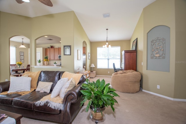 11021 Silver Dancer Dr, Riverview, FL 33579 - living area featuring arched walkways, a chandelier, light colored carpet, baseboards, and ceiling fan