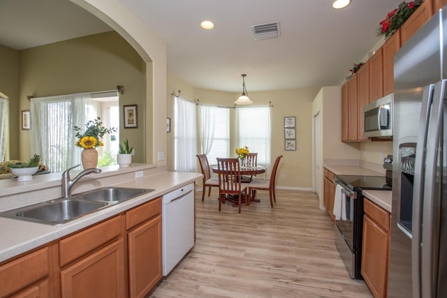 11021 Silver Dancer Dr, Riverview, FL 33579 - kitchen featuring stainless steel appliances, a sink, light wood-style flooring, light countertops, and recessed lighting