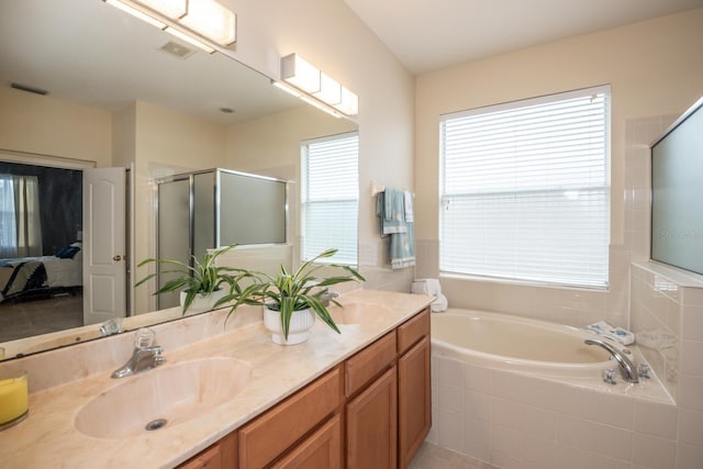 11021 Silver Dancer Dr, Riverview, FL 33579 - ensuite bathroom featuring double vanity, a shower stall, healthy amount of natural light, and a bath