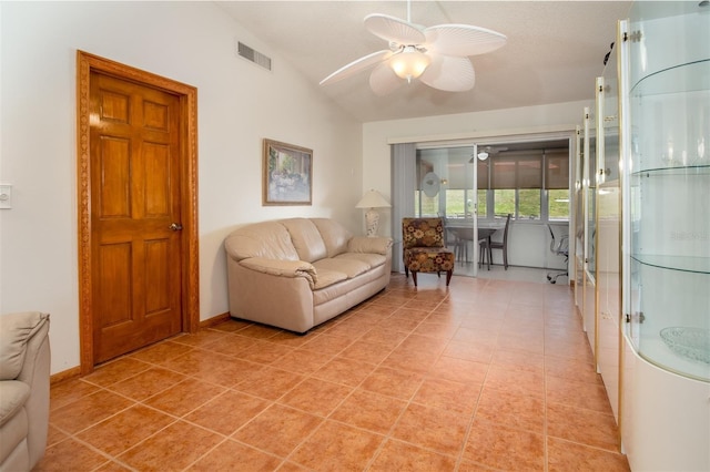 living room with a ceiling fan, lofted ceiling, and baseboards