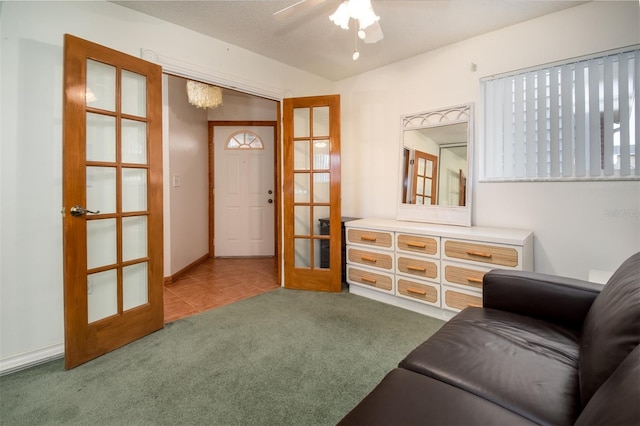 carpeted living room featuring french doors and a ceiling fan