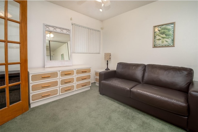 carpeted living room with a ceiling fan