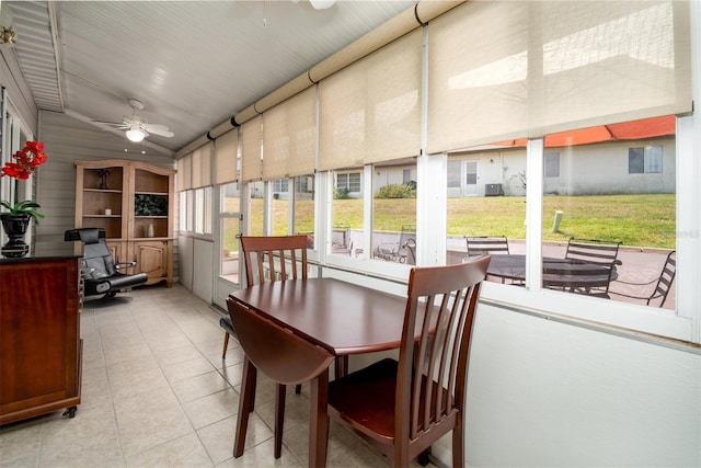 sunroom featuring ceiling fan and outdoor dining area