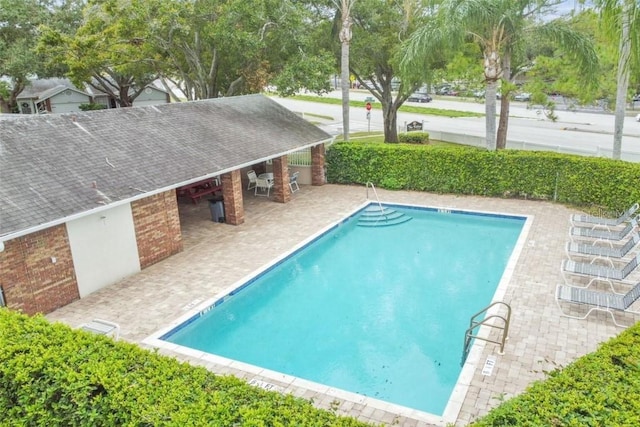 community pool with a patio area