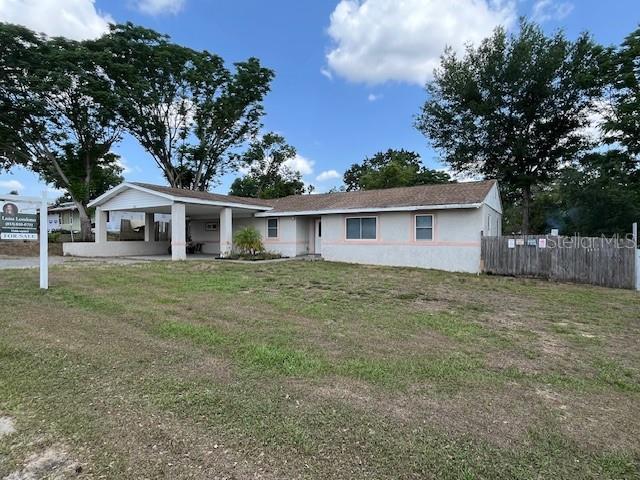 single story home with stucco siding and a carport