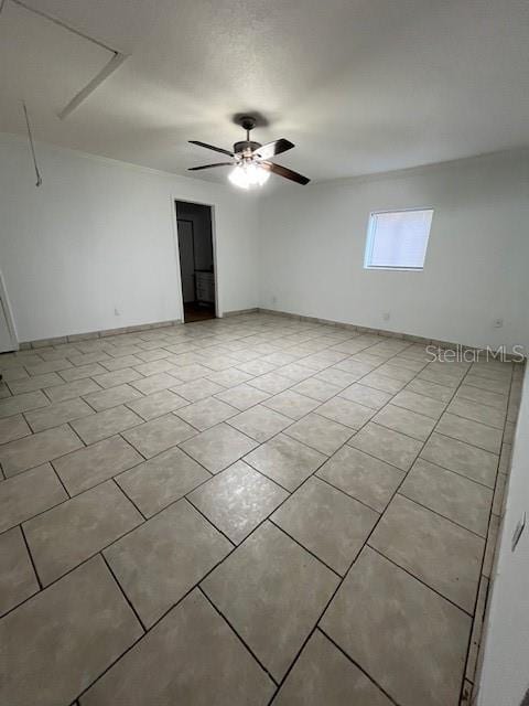 unfurnished room featuring light tile patterned flooring and a ceiling fan