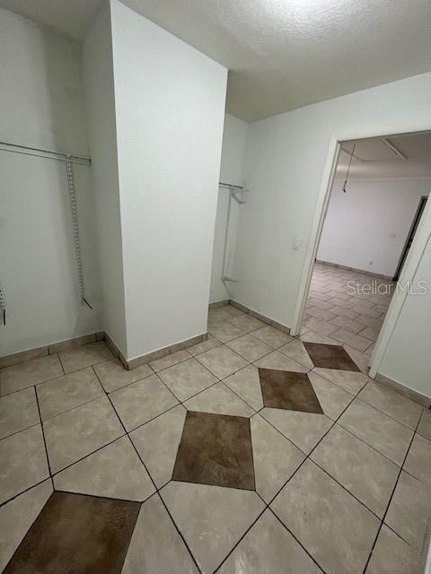 bathroom with tile patterned floors and baseboards