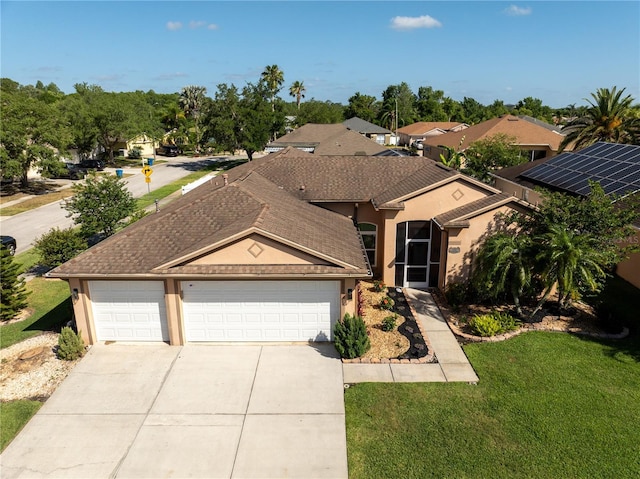 ranch-style house with an attached garage, concrete driveway, stucco siding, and a front yard