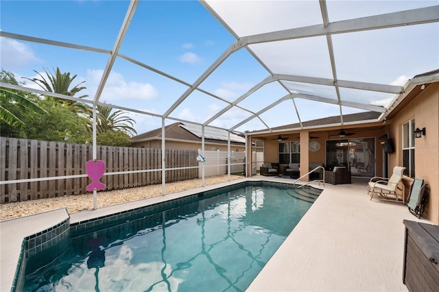 view of pool with a ceiling fan, a fenced backyard, a patio area, and a lanai