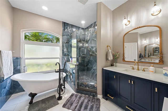 full bathroom with a stall shower, vanity, a freestanding tub, vaulted ceiling, and tile patterned flooring