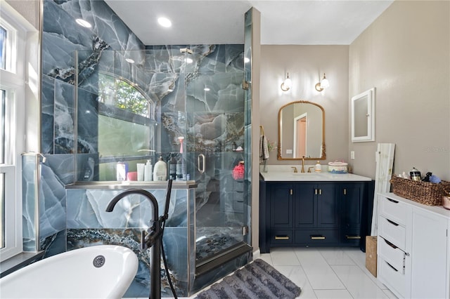 full bath featuring a shower stall, a soaking tub, vanity, and marble finish floors