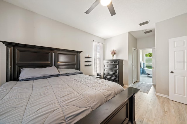 bedroom with multiple windows, light wood-style flooring, baseboards, and ceiling fan