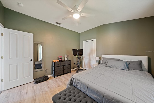 bedroom featuring vaulted ceiling, wood finished floors, baseboards, ceiling fan, and a closet