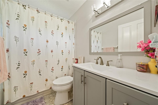 bathroom with toilet, vanity, and a shower with curtain