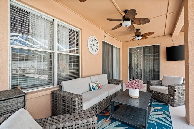 view of patio with an outdoor living space and ceiling fan