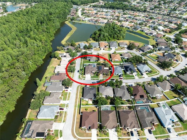 aerial view of property and surrounding area featuring nearby suburban area and a nearby body of water
