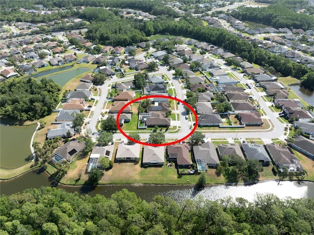 aerial view of property's location with nearby suburban area and a nearby body of water