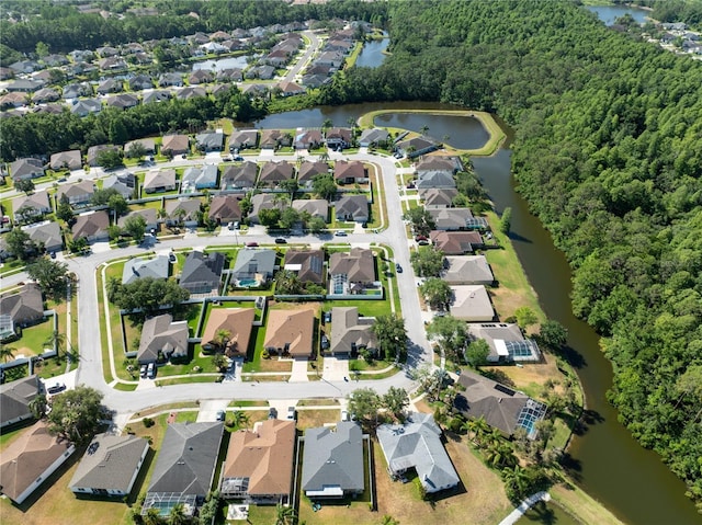 aerial view of property's location featuring a large body of water and nearby suburban area
