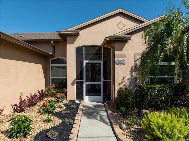 doorway to property with stucco siding