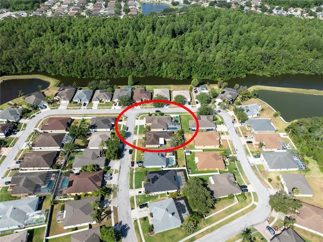 view of property location featuring a nearby body of water and nearby suburban area