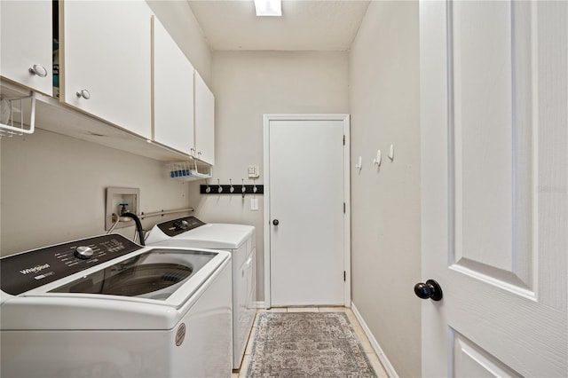 washroom featuring washer and dryer and cabinet space