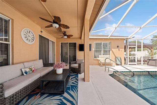 view of patio / terrace featuring an outdoor hangout area, a ceiling fan, an outdoor pool, and glass enclosure