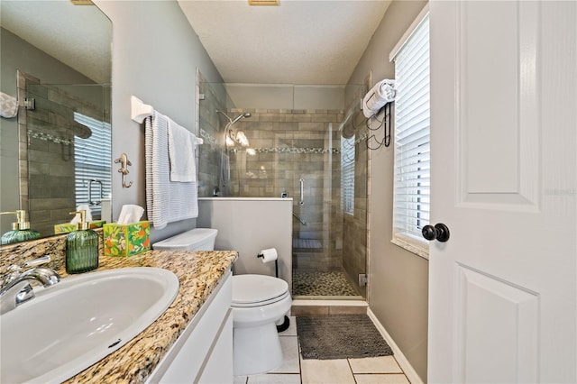 full bath featuring tile patterned flooring, plenty of natural light, a stall shower, vanity, and a textured ceiling