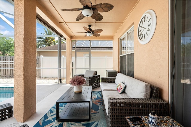 sunroom / solarium featuring a ceiling fan, an outdoor hangout area, and plenty of natural light