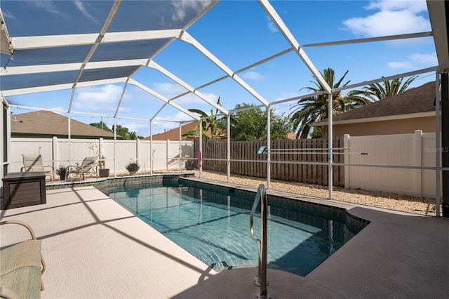view of pool with a patio, a fenced backyard, and glass enclosure