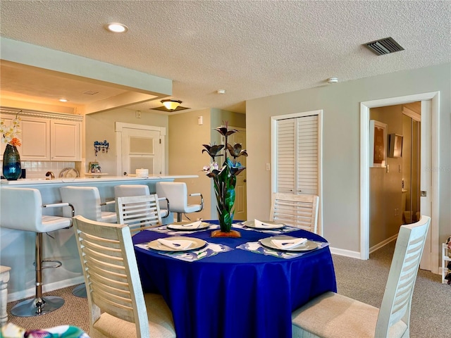 100 Bluff View Dr Unit 105C, Belleair Bluffs, FL 33770 - carpeted dining room with recessed lighting, a textured ceiling, and baseboards