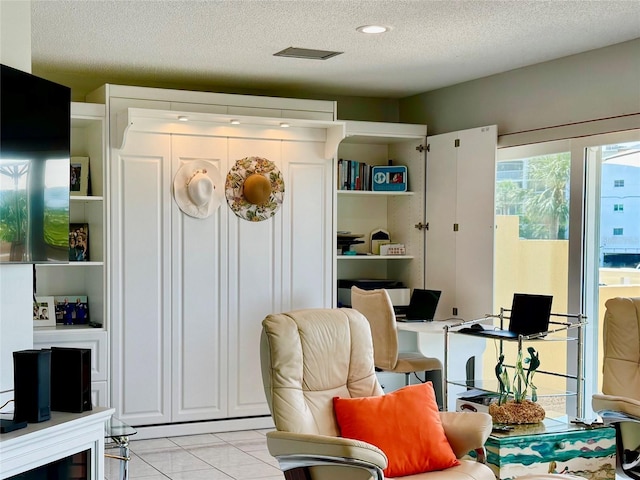 100 Bluff View Dr Unit 105C, Belleair Bluffs, FL 33770 - sitting room featuring a textured ceiling and light tile patterned flooring